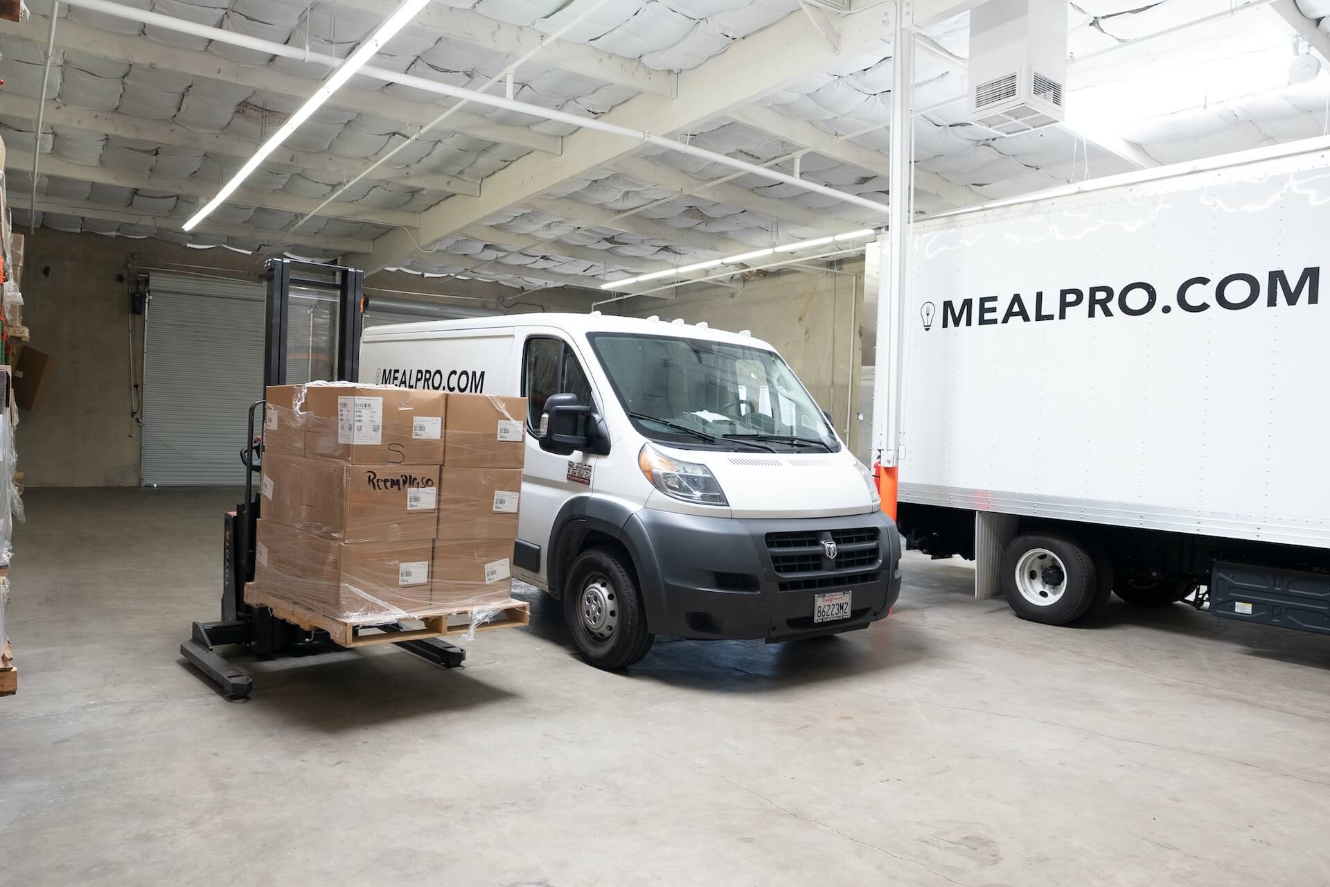 Van and a pile of packed box on a pallet